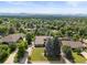 Aerial view of a well-situated property featuring mature trees and mountain views, ideal for serene living at 1025 S Butler Way, Lakewood, CO 80226