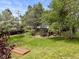 Backyard featuring lawn, wooden gazebo, and mature shade trees at 1025 S Butler Way, Lakewood, CO 80226