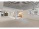 Large finished basement space with patterned carpet, decorative ceiling, and staircase at 1025 S Butler Way, Lakewood, CO 80226