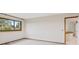 Neutral bedroom with a large window, carpet, and a view of the upstairs hallway at 1025 S Butler Way, Lakewood, CO 80226
