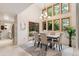 Open dining room with large windows, a modern chandelier, and backyard views at 1025 S Butler Way, Lakewood, CO 80226