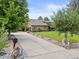 Stunning exterior elevation showcases a large driveway and meticulously maintained lawn at 1025 S Butler Way, Lakewood, CO 80226