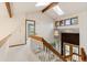 Bright foyer with skylights, wood accents, and a view of the living space and staircase at 1025 S Butler Way, Lakewood, CO 80226