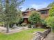 Charming front exterior with lush landscaping and a stone retaining wall at 1025 S Butler Way, Lakewood, CO 80226