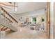 Bright living room features an open staircase, tiled floors, and abundant natural light at 1025 S Butler Way, Lakewood, CO 80226