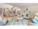 Open living space with a staircase and a view of the dining room beyond at 1025 S Butler Way, Lakewood, CO 80226