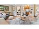 Open living room with a stone fireplace and view to dining room at 1025 S Butler Way, Lakewood, CO 80226