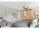 Inviting bedroom featuring ceiling fan, sliding barn door to bath, and calm color palette at 1025 S Butler Way, Lakewood, CO 80226