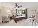 Serene main bedroom featuring a plush bed, stylish seating, and serene backyard views at 1025 S Butler Way, Lakewood, CO 80226