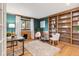 Bright office with hardwood floors, built-in shelving, and a large window at 1025 S Butler Way, Lakewood, CO 80226