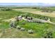 Serene property featuring a winding driveway, mature trees, and well-maintained landscaping at 1335 S Kio St, Watkins, CO 80137