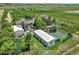 Expansive property featuring multiple structures, lush greenery, and a peaceful rural setting at 1335 S Kio St, Watkins, CO 80137