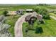 Scenic property with multiple buildings, a winding driveway, and abundant green space at 1335 S Kio St, Watkins, CO 80137
