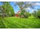 Large grassy backyard featuring mature trees and exterior view of the home at 1335 S Kio St, Watkins, CO 80137