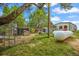 Grassy backyard features fenced kennels, outbuilding and propane tanks at 1335 S Kio St, Watkins, CO 80137