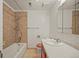 Cozy bathroom with neutral tiles, tub and shower, and well-lit vanity at 1335 S Kio St, Watkins, CO 80137