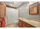 Cozy bathroom featuring a vanity with a granite countertop and a shower with a curtain at 1335 S Kio St, Watkins, CO 80137