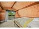 Cozy bedroom with wood paneled walls, a comfortable bed, and access to an outdoor balcony at 1335 S Kio St, Watkins, CO 80137
