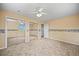 Bright bedroom featuring neutral carpet, ceiling fan, mirrored closets, and warm wallpaper at 1335 S Kio St, Watkins, CO 80137