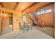 Wood-paneled dining room with a round table and chairs, adjacent to a staircase and doorway at 1335 S Kio St, Watkins, CO 80137