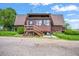 Charming home featuring wood siding, front porch, and gravel driveway at 1335 S Kio St, Watkins, CO 80137
