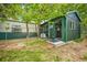 Exterior view of dog kennels building surrounded by grass and trees at 1335 S Kio St, Watkins, CO 80137