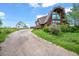 Exterior view of home with unique architecture, long driveway, and grassy yard at 1335 S Kio St, Watkins, CO 80137