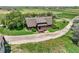 A-frame home with a brown roof and natural landscaping sits on a spacious lot in a serene, rural setting at 1335 S Kio St, Watkins, CO 80137