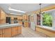 Bright kitchen with wooden cabinets, granite countertops, and a large window at 1335 S Kio St, Watkins, CO 80137