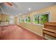 Bright living room featuring carpeted floor, multiple windows with backyard views, and neutral paint at 1335 S Kio St, Watkins, CO 80137