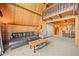 Cozy living room with wood paneled walls, comfortable seating, and views of the upper level at 1335 S Kio St, Watkins, CO 80137