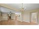 Spacious living area with hardwood floors, chandelier, and open floor plan at 1335 S Kio St, Watkins, CO 80137
