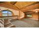 Cozy loft space with wood paneled walls, comfortable seating, and a window with scenic views at 1335 S Kio St, Watkins, CO 80137