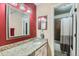 Bathroom features granite countertops, neutral walls and a large decorative mirror at 7893 Allison Way # 101, Arvada, CO 80005