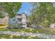 Rear exterior of building with multiple stories, decks and a lovely creek at 7893 Allison Way # 101, Arvada, CO 80005