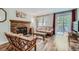 Comfortable living room with fireplace, hardwood floors, and access to outdoor balcony at 7893 Allison Way # 101, Arvada, CO 80005
