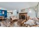 Bright living room featuring wood flooring, brick fireplace, and lots of room for entertaining and relaxing at 7893 Allison Way # 101, Arvada, CO 80005