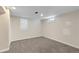 Finished basement with neutral carpet, white walls, and natural light from window at 2230 Jamaica St, Aurora, CO 80010