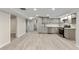 Finished basement with a modern kitchenette featuring stainless steel appliances and gray cabinetry at 2230 Jamaica St, Aurora, CO 80010