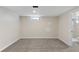 Finished basement area with gray carpet and view of the en-suite bathroom at 2230 Jamaica St, Aurora, CO 80010