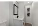 Stylish bathroom featuring white vanity with modern fixtures and decorative wall art at 2230 Jamaica St, Aurora, CO 80010