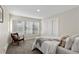 Cozy bedroom features a large window and neutral decor at 2230 Jamaica St, Aurora, CO 80010