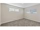Neutral bedroom with carpet, base trim, and two windows offering ample natural light at 2230 Jamaica St, Aurora, CO 80010