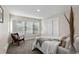 Cozy bedroom features a large window and neutral decor at 2230 Jamaica St, Aurora, CO 80010