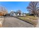 Quaint home showcasing a brick facade, a wide driveway, and a detached garage at 2230 Jamaica St, Aurora, CO 80010