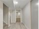 Basement hallway featuring light gray flooring and access to rooms at 2230 Jamaica St, Aurora, CO 80010