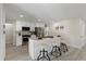Bright, modern kitchen features stainless steel appliances, white cabinets, and an island with seating at 2230 Jamaica St, Aurora, CO 80010