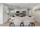 Bright, modern kitchen features stainless steel appliances, white cabinets, and an island with seating at 2230 Jamaica St, Aurora, CO 80010