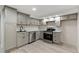Basement kitchen with light gray cabinets and stainless steel appliances at 2230 Jamaica St, Aurora, CO 80010