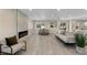 Open-concept living area featuring modern fireplace and dining area at 2230 Jamaica St, Aurora, CO 80010
